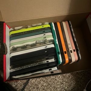 Shoe box full of iPhone 13 promax phone cases.